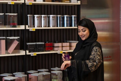 Saudi Woman Testing Perfume in Retail Shop