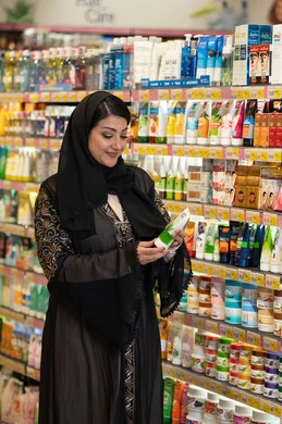 Arab Woman Shopping for Skincare in Supermarket