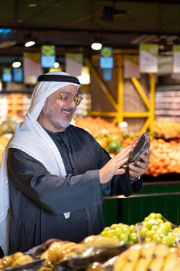 Senior Arab Man Shopping for Produce in Supermarket