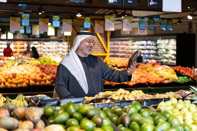 Emirati Man Shopping for Fresh Produce in Supermarket