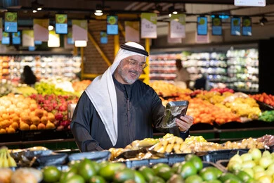 Emirati Man Shopping for Produce in Supermarket