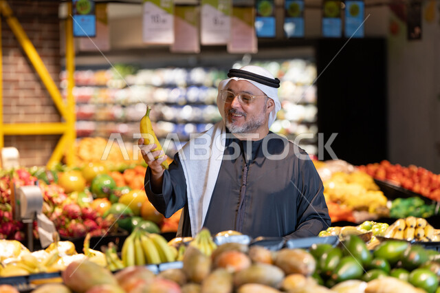 Emirati Man Shopping for Fresh Fruit in Supermarket