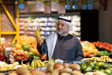 Emirati Man Shopping for Fresh Fruit in Supermarket
