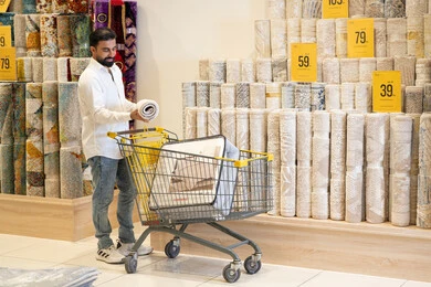 Arab Man Shopping for Carpets in Home Decor Store