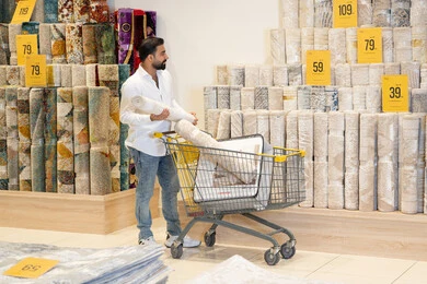 Arab Man Buying Rug in Home Furnishing Store