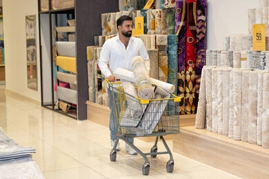 Saudi Man Shopping for Carpets in Home Store