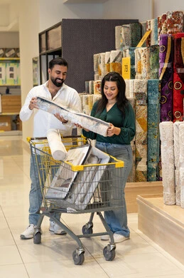 Arab Couple Shopping for Carpets in Home Decor Store