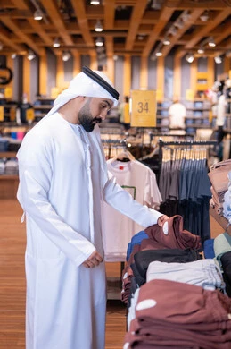 Emirati Man Shopping for Clothes in Retail Store