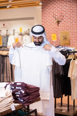 Emirati Man Shopping for Clothes in Retail Store