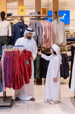 Emirati Father and Son Shopping in Clothing Store