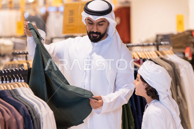 أب إماراتي وابنه يتسوقان الملابس التقليدية في المتجر