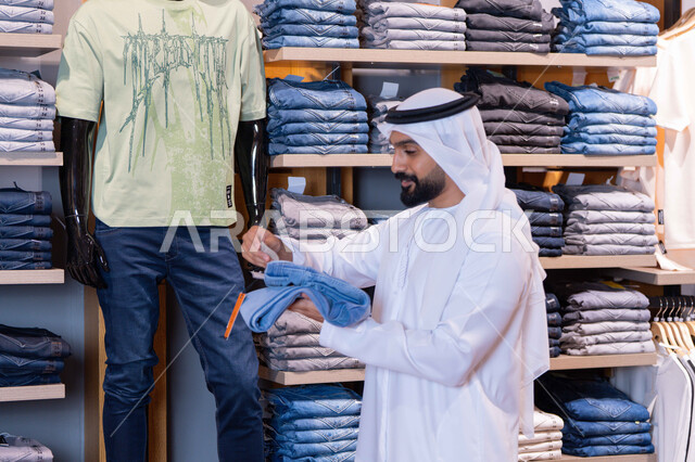 Emirati Man Shopping in Modern Clothing Retail Store