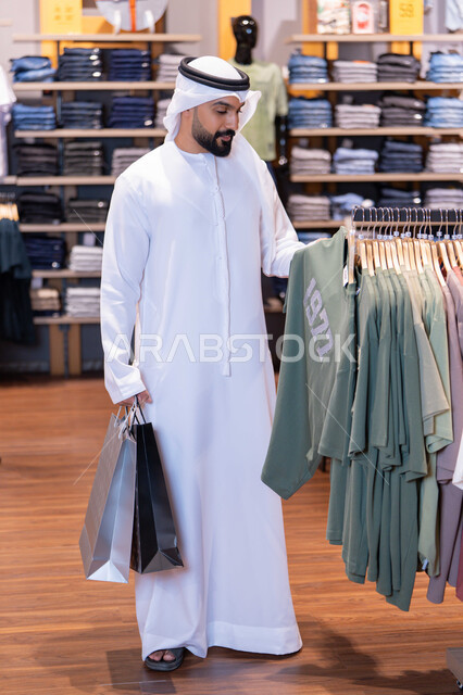 Emirati Man Shopping for Clothing in Retail Store