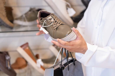 Arab Man Shopping for Shoes in Retail Store
