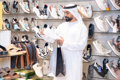 Emirati Man Shopping for Sneakers in Retail Store