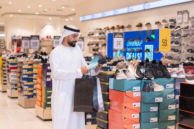 Emirati Man Shopping for Sneakers in Retail Store