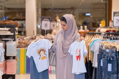 Saudi Woman Shopping for Clothes in Retail Mall