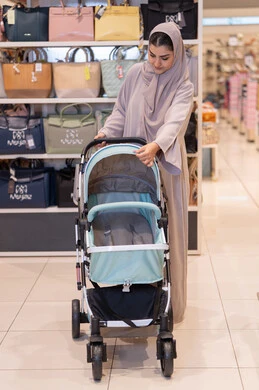 Arab Woman with Baby Stroller in Shopping Mall
