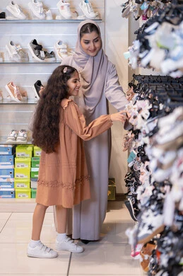 Saudi Woman and Daughter Shopping in Shoe Store