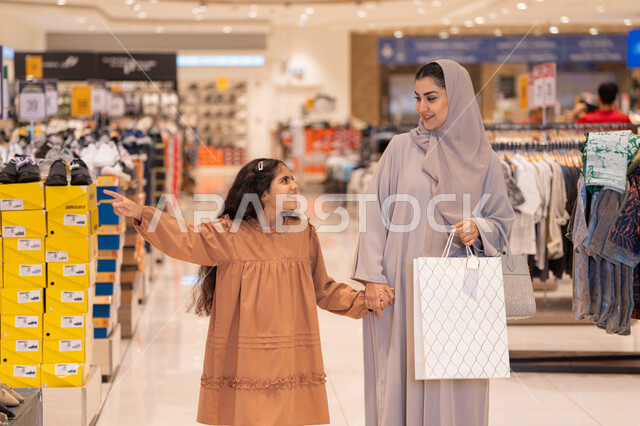 Arab Mother and Daughter Shopping in Modern Mall