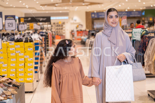 Arab Mother and Daughter Shopping in Retail Store