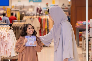 Emirati Mother and Daughter Shopping in Retail Store