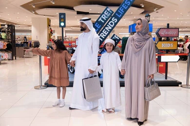Emirati Family Shopping in Modern Mall with Bags