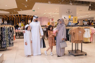 Emirati Family Shopping in Modern Clothing Store