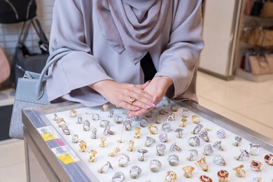 Arab Woman Shopping for Gold Jewelry Rings in Store Arab Woman Shopping for Gold Jewelry Rings in Store