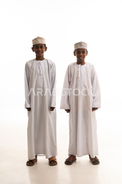 Omani Boys in Traditional White Dishdasha and Kumma