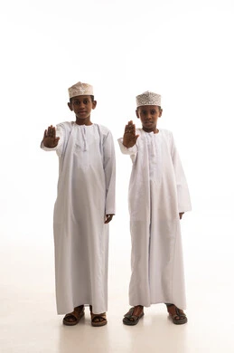 Omani Boys in Traditional Dress Making Stop Gesture