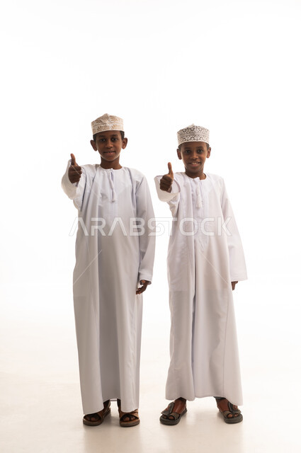 Omani Boys in Traditional Dress Giving Thumbs Up