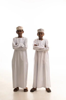 Omani Boys in Traditional Dishdasha on White Background