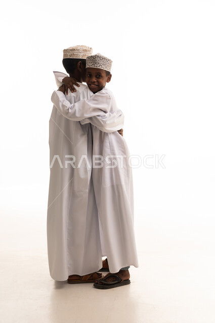 Omani Boys Hugging in Traditional Dress White Background