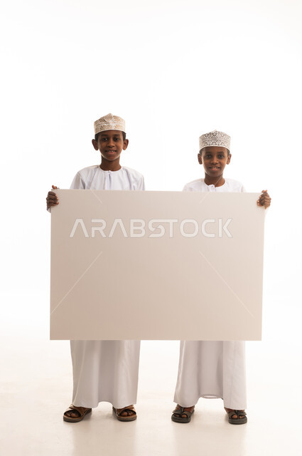 Omani Boys Holding Blank White Placard in Studio