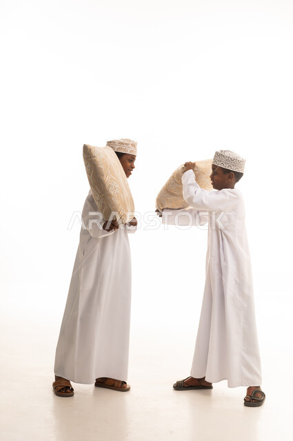 Omani Boys Playing Pillow Fight in Studio