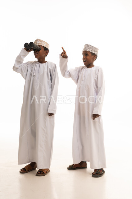 Omani Boys in Traditional Dress with Binoculars