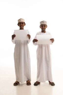 Two Omani Boys with Blank Signs in Traditional Dress