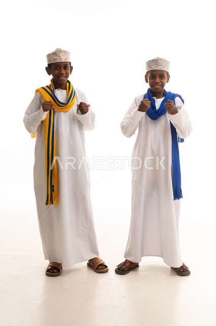 Omani Boys in Traditional Dishdasha and Kumma Hats