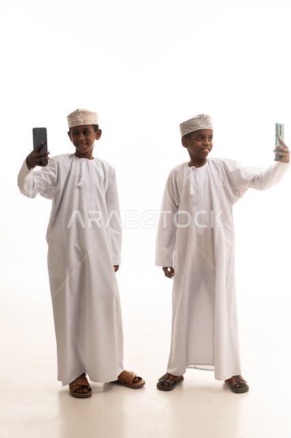 Omani Boys in Traditional Dress Taking Selfies