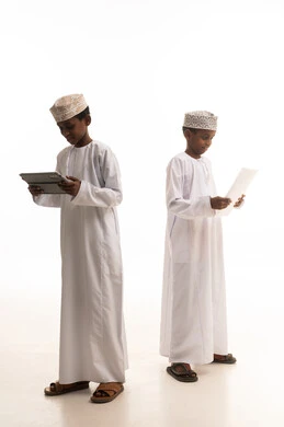 Omani Boys Using Tablet and Paper in Studio