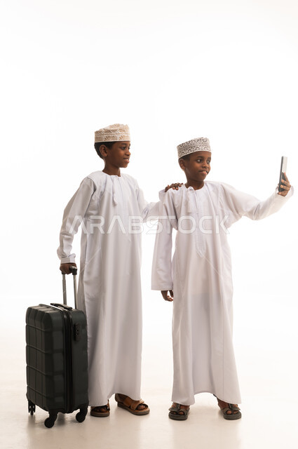 Omani Boys with Suitcase Taking Selfie in Studio