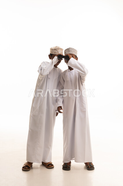 Omani Boys in Traditional Dishdasha Using Binoculars