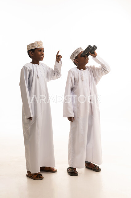 Omani Boys in Traditional Dress Using Binoculars