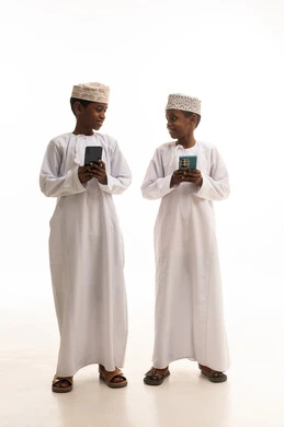 Omani Boys in Traditional Dress with Smartphones