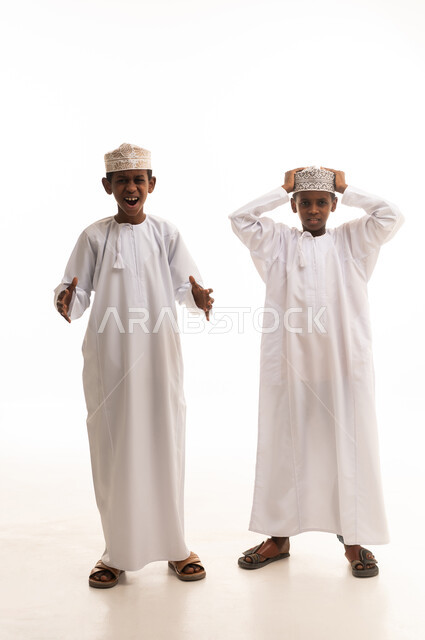 Omani Boys in Traditional Dishdasha Expressing Surprise