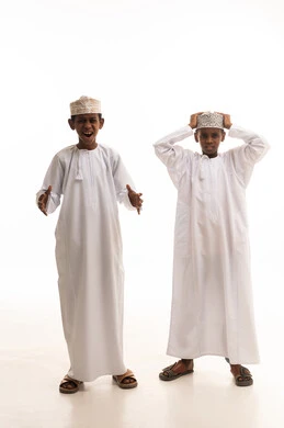 أطفال عمانيون بالزي التقليدي بتعابير وجه مندهشة