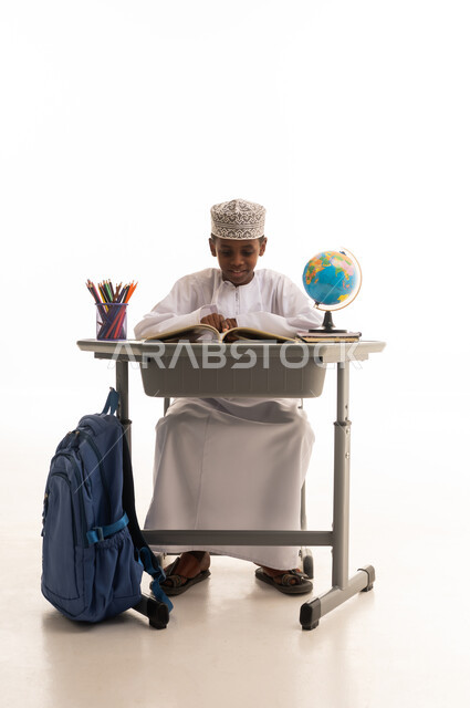 Omani Student Boy Reading at School Desk Studio