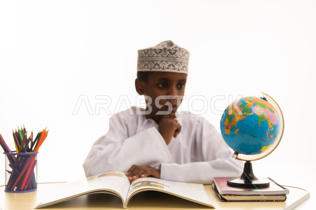 Omani Boy Student Studying World Globe at Desk