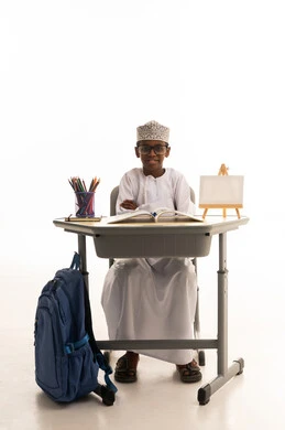Omani Schoolboy at Desk on White Background